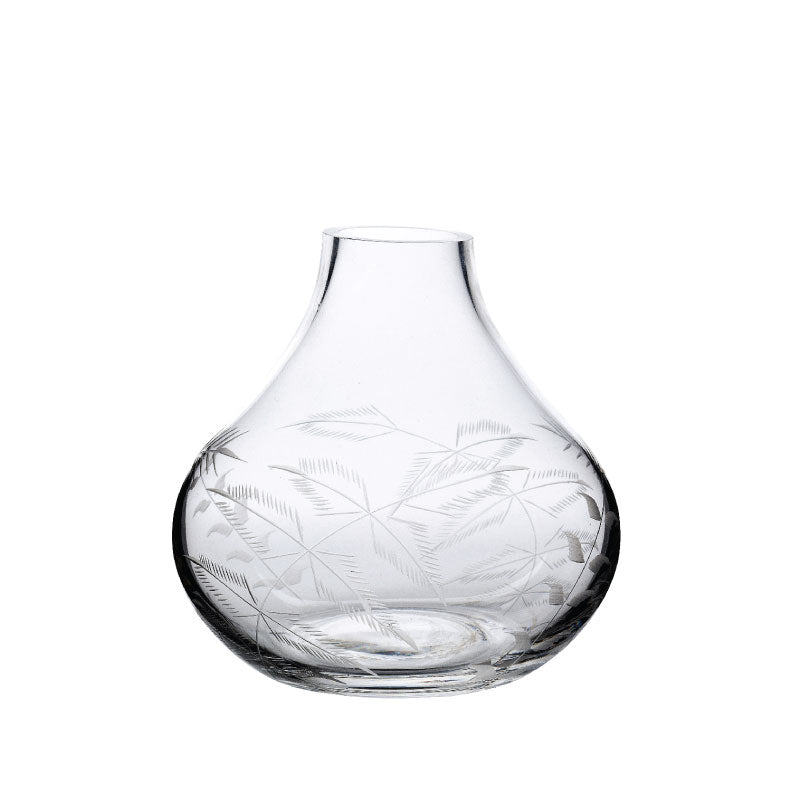 Front view of small crystal vase showcasing an engraved fern design against a white background