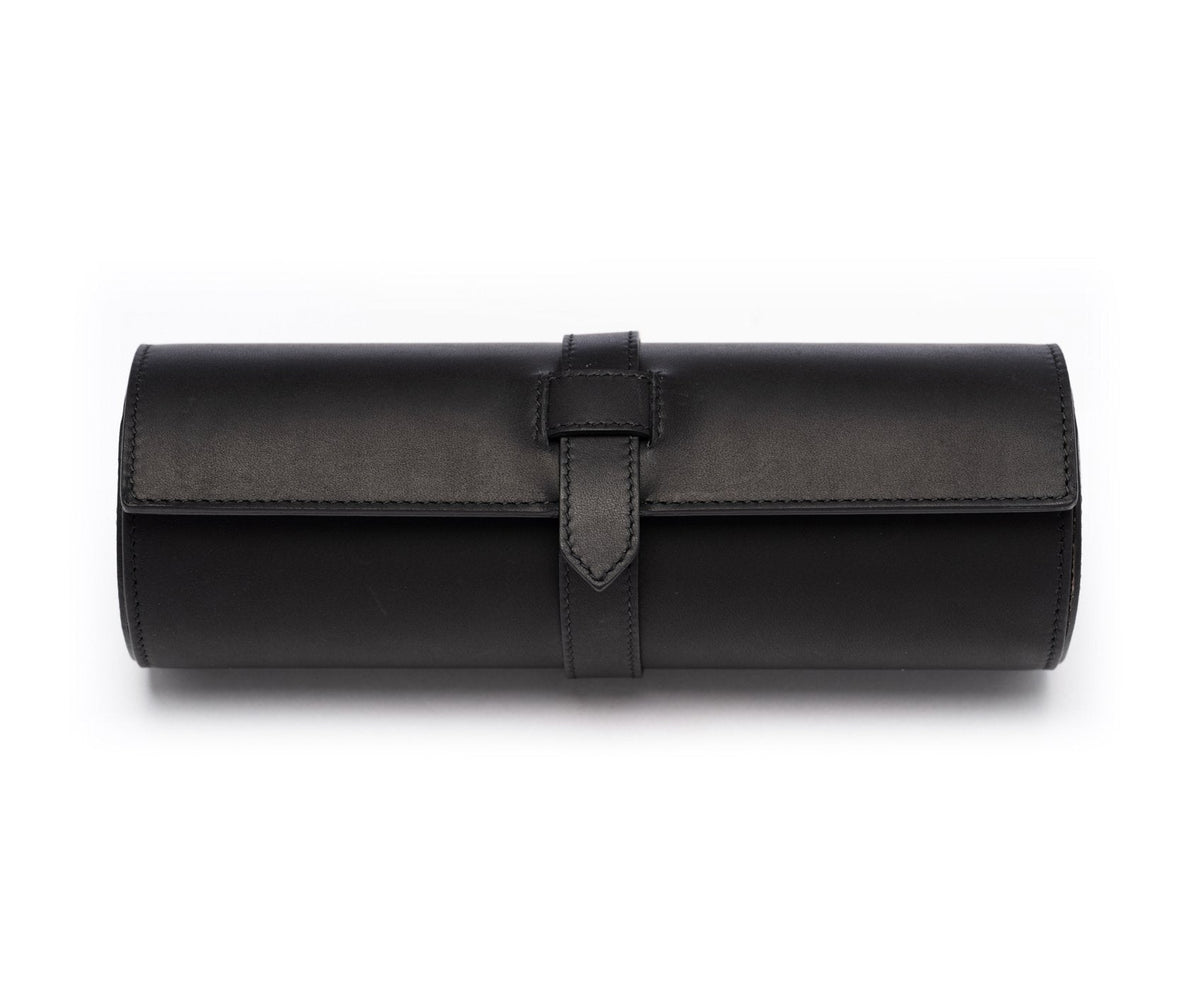 Front view of Watch Roll No. 504 in black leather with tab fastening and cylindrical roll on white background