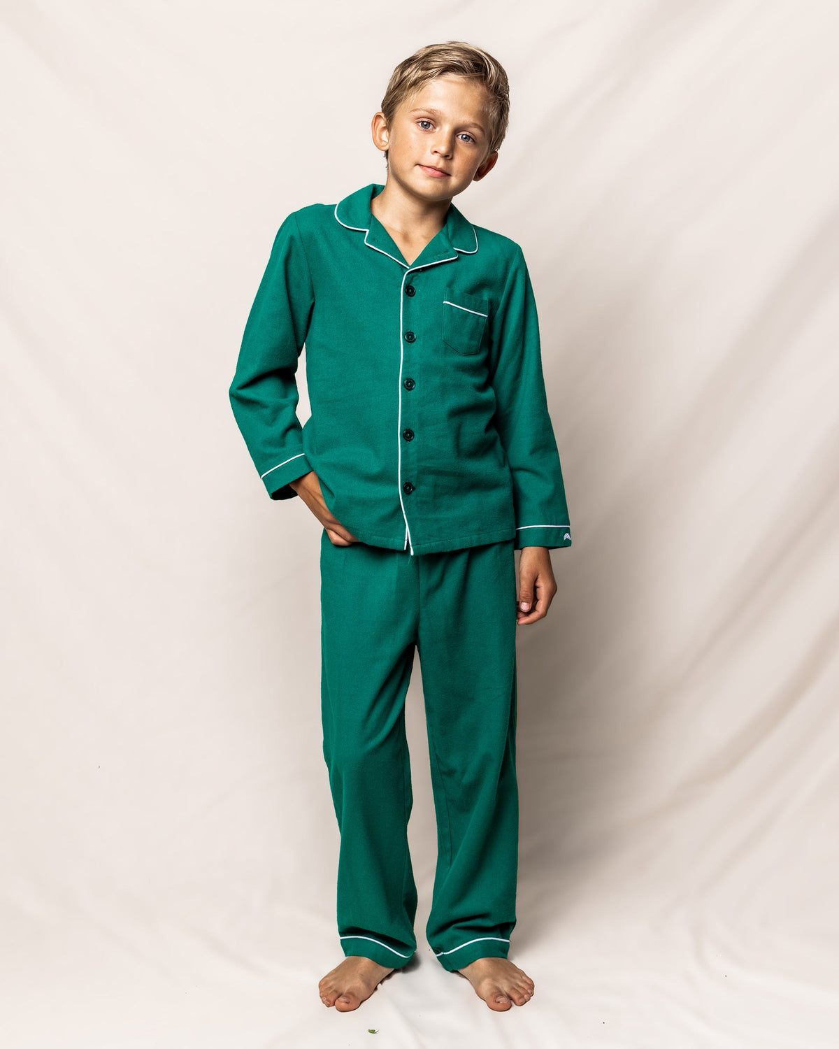 Front view of Children’s Forest Green Flannel Pajama Set showcasing white contrast piping, button front shirt, and chest pocket on a neutral background
