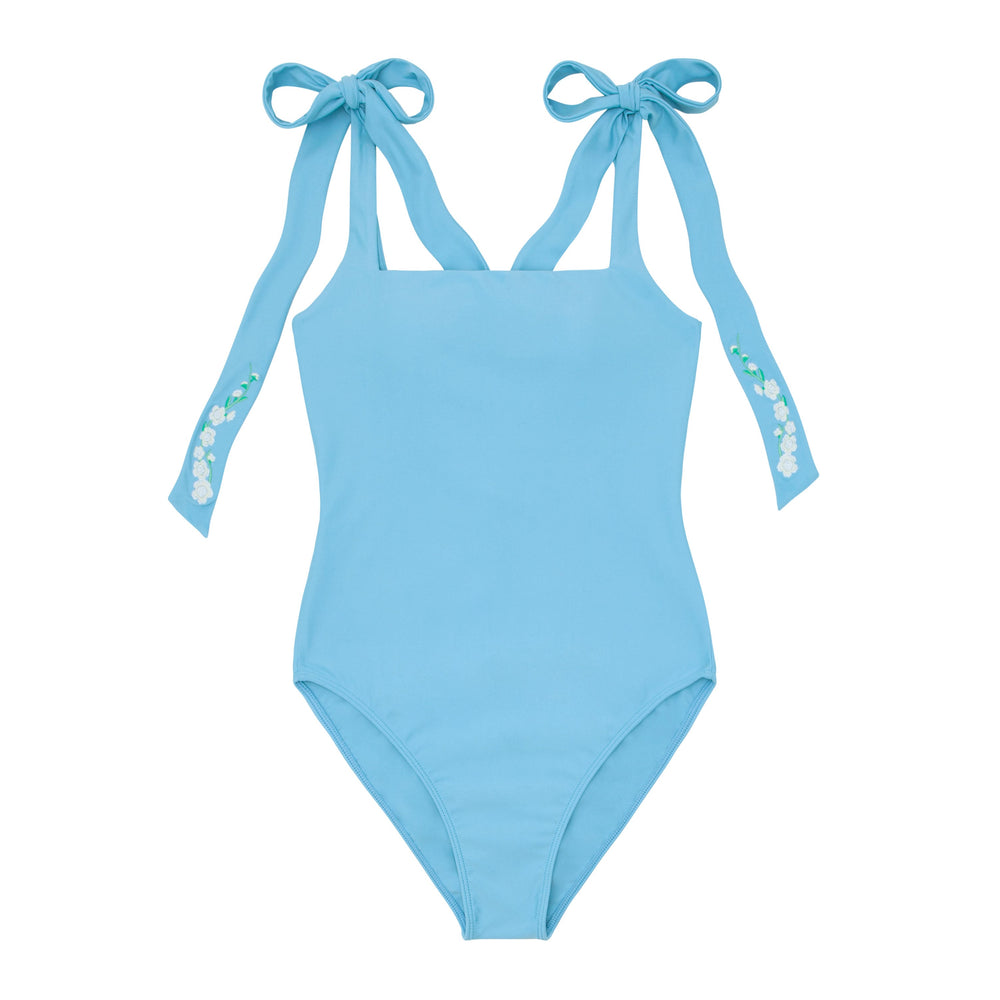Front view of Lagoon Tie Knot one-piece swimsuit showcasing adjustable tie shoulder straps with hibiscus embroidery on white background