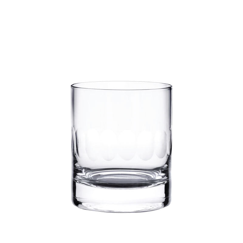 Front view of the Pair of Crystal Whiskey Glasses with Lens Design, showing one glass against white