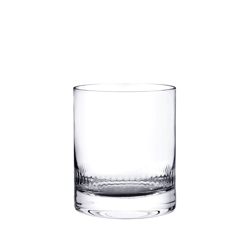 Front view of crystal whiskey glass showcasing hand-engraved spears design on a white background