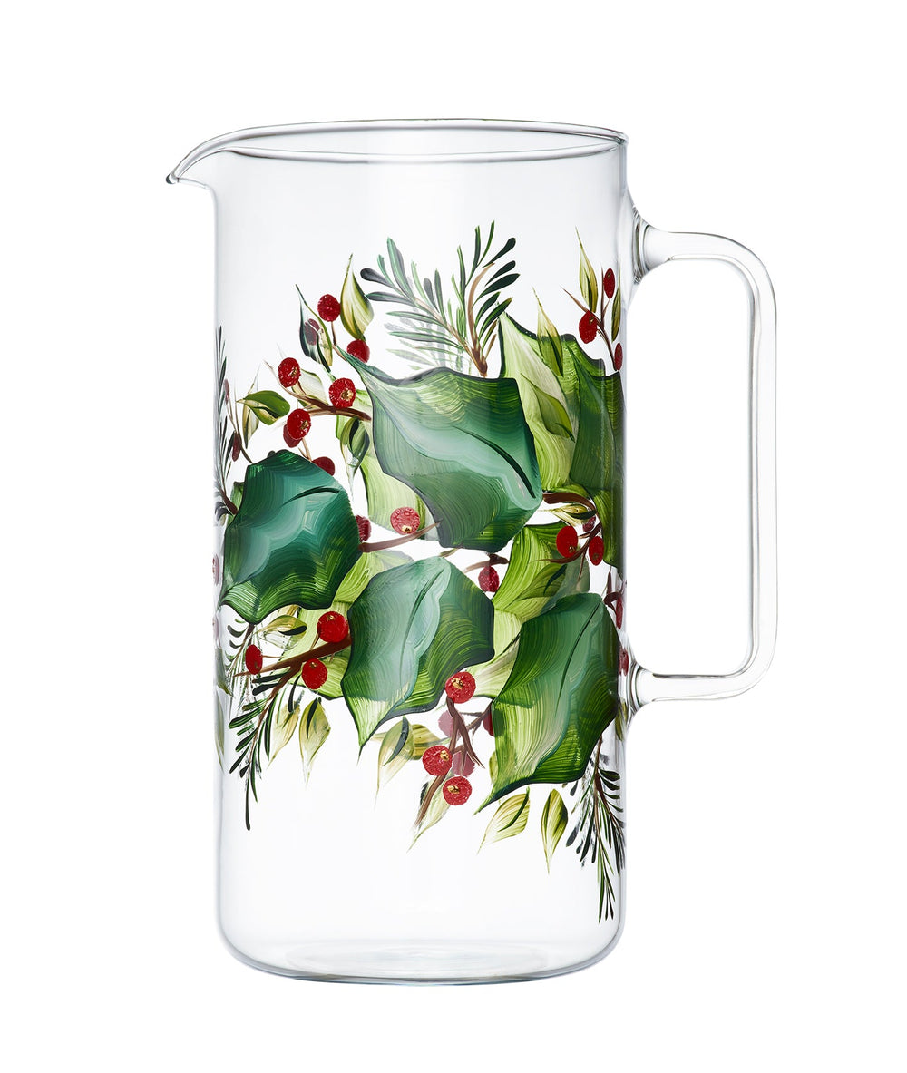 Side view of Holly glass jug showcasing hand-painted green holly leaves and red berries on clear glass with white background
