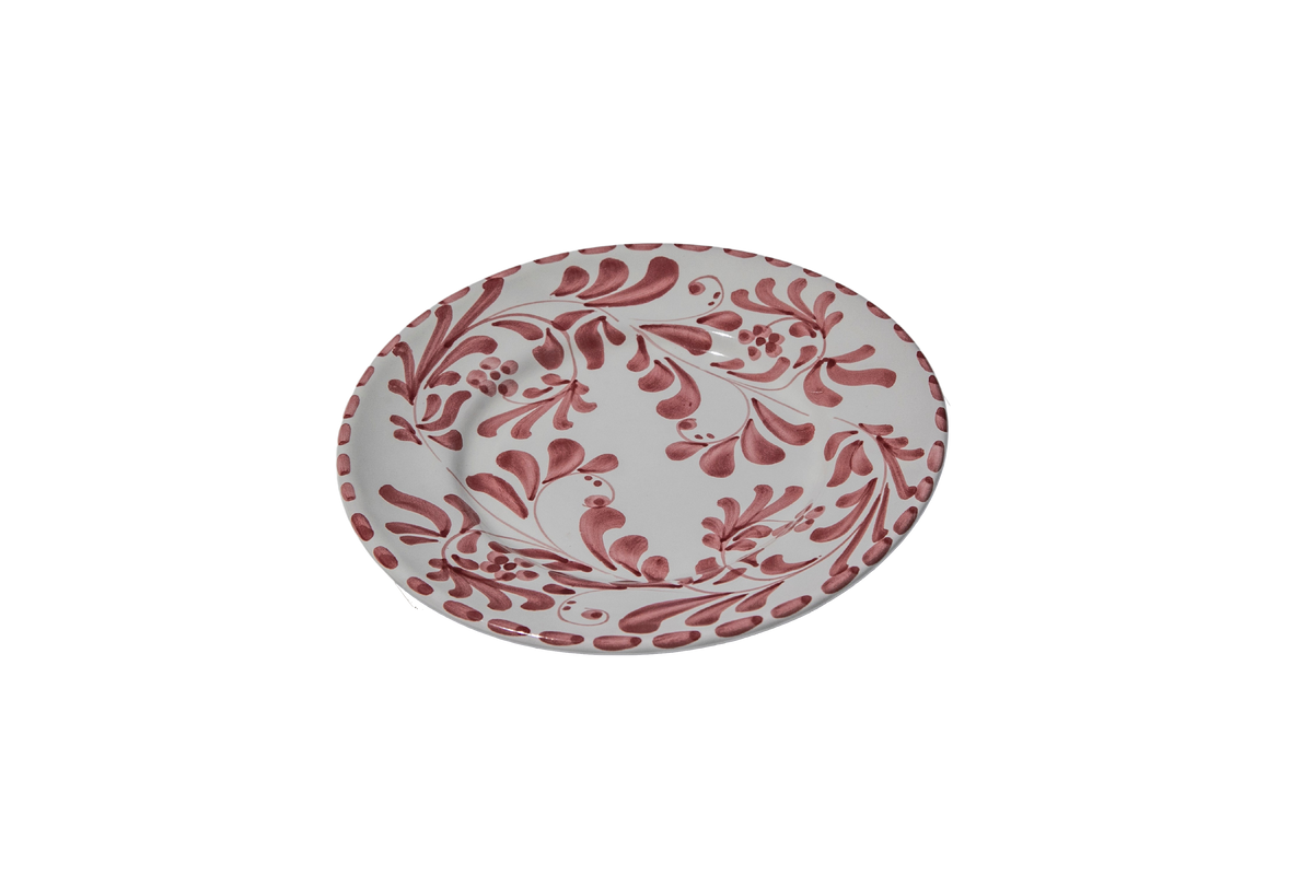 Angled view of Salad and Dessert Plate in Vino Tinto showcasing subtle leafy impressions with black background