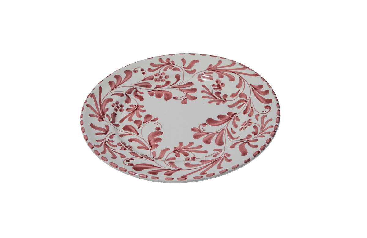 Angled view of Dinner Plate in Vinto Tinto showcasing swirling leafy impressions with a black background