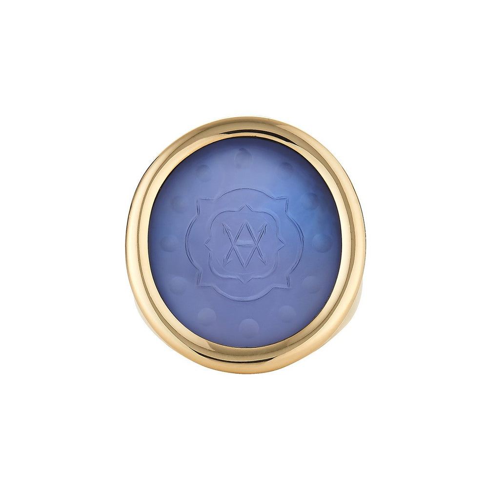 Top view of Large Bespoke Ring showing blue chalcedony intaglio with engraved quatrefoil motif set in 18K gold bezel on white
