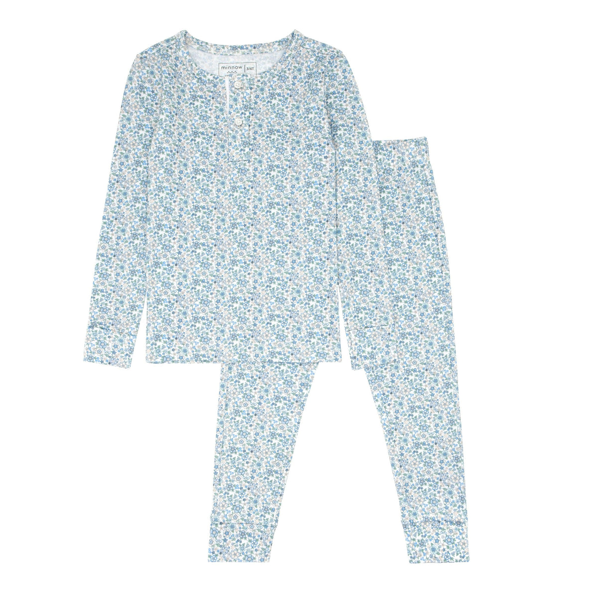 Flat lay of unisex slate floral Pima pajama set showing long-sleeve henley top and matching pants on white background