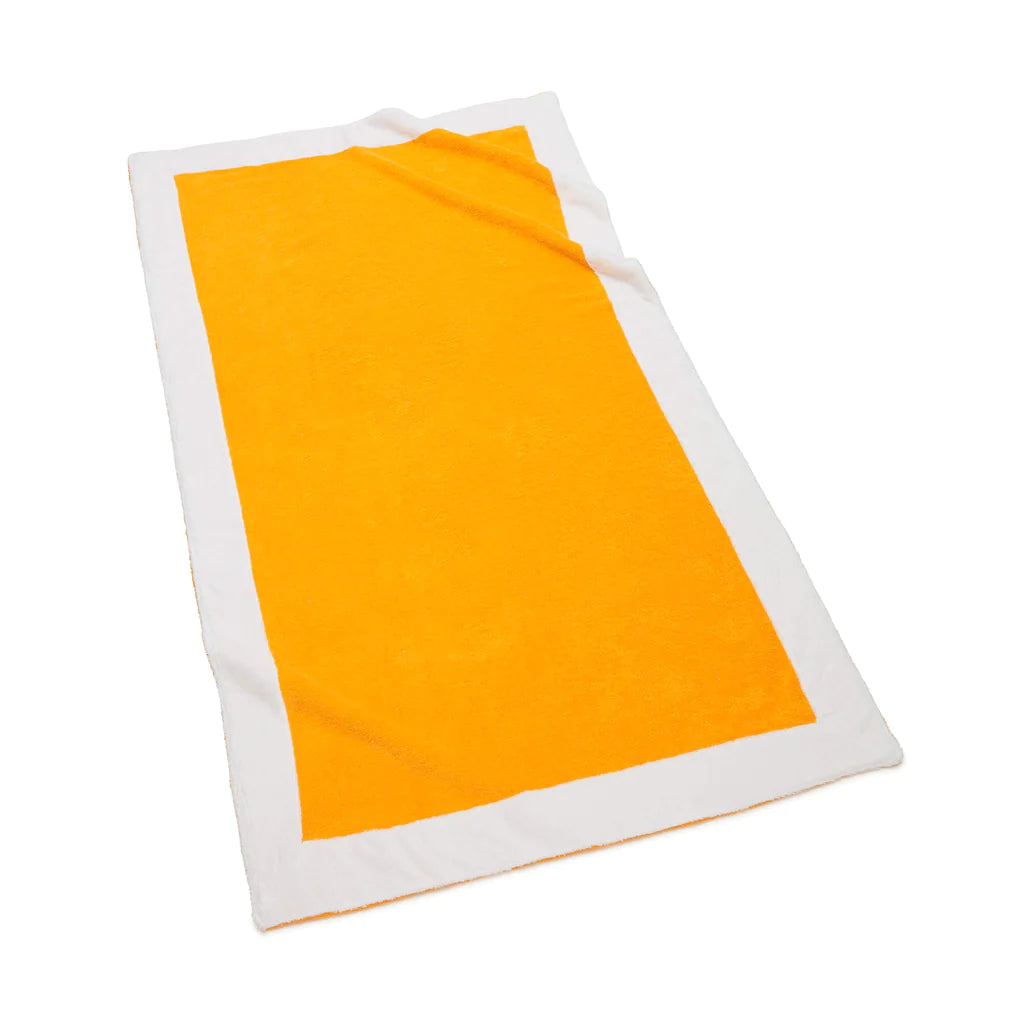 Angled view of Capri Beach Towel showcasing lemon color center with wide white border on white background