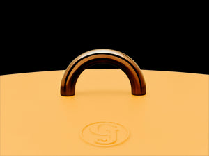 Enameled cast-iron Dutch oven in mustard yellow - top handle close-up