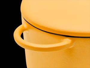 Enameled cast-iron Dutch oven in mustard yellow - handle close-up