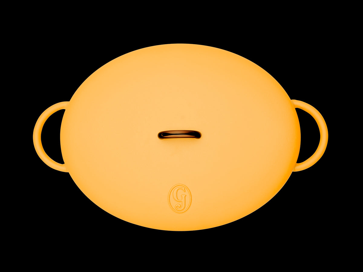 Enameled cast-iron Dutch oven in mustard yellow - top down view with lid