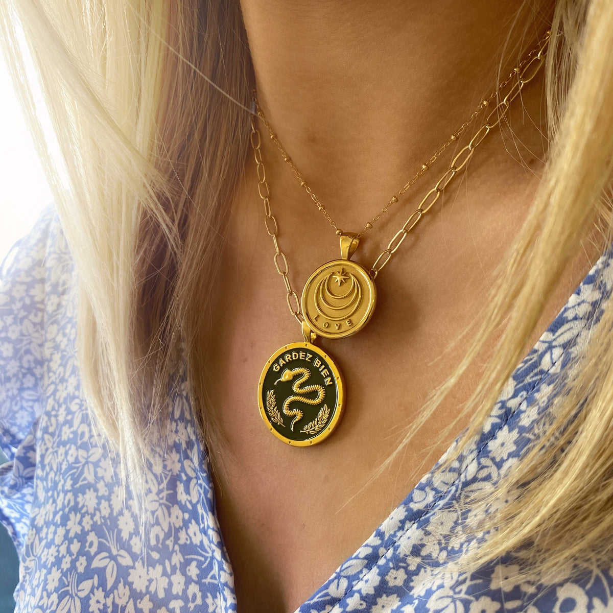 Close-up view of Protect JW Original Pendant Coin Necklace In Green Enamel showcasing its snake design on a model