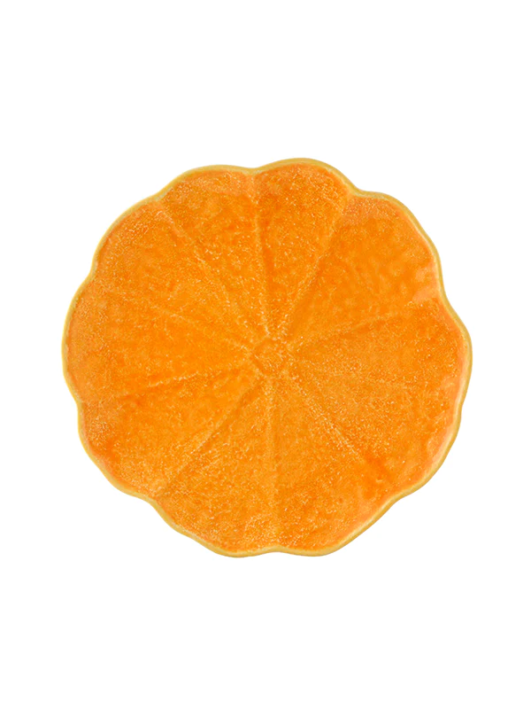 Top-down view of pumpkin dinner plate showing scalloped pumpkin shape and glossy orange glazed finish on white background