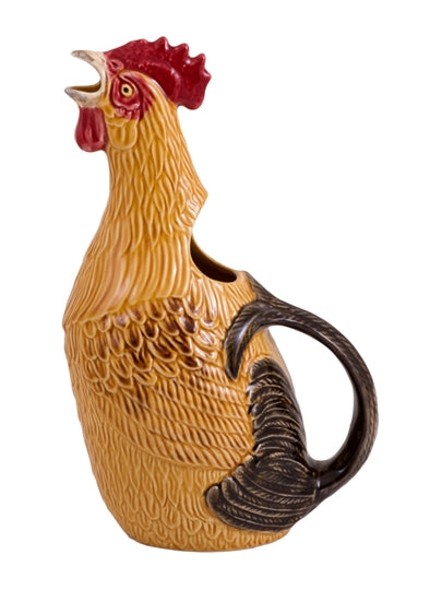 Front 3/4 view of rooster pitcher with textured feathers, red comb, open-beak spout and tail-shaped handle on white background