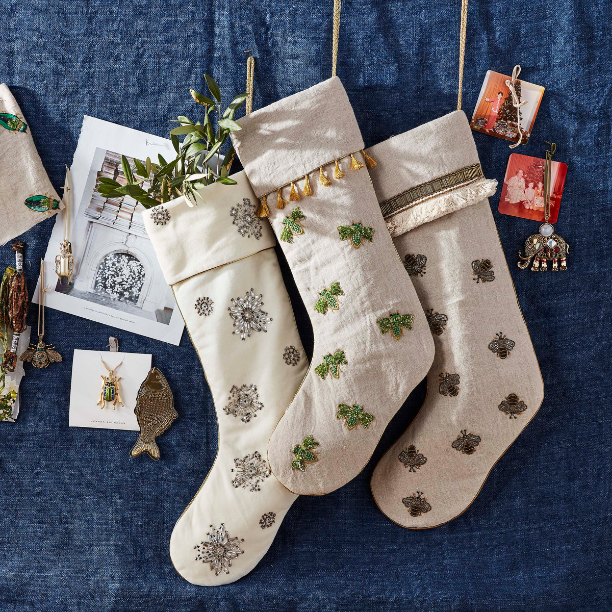 Top-down view of Snowflake stocking with ivory cotton velvet and hand-beaded snowflake embellishments on dark blue background