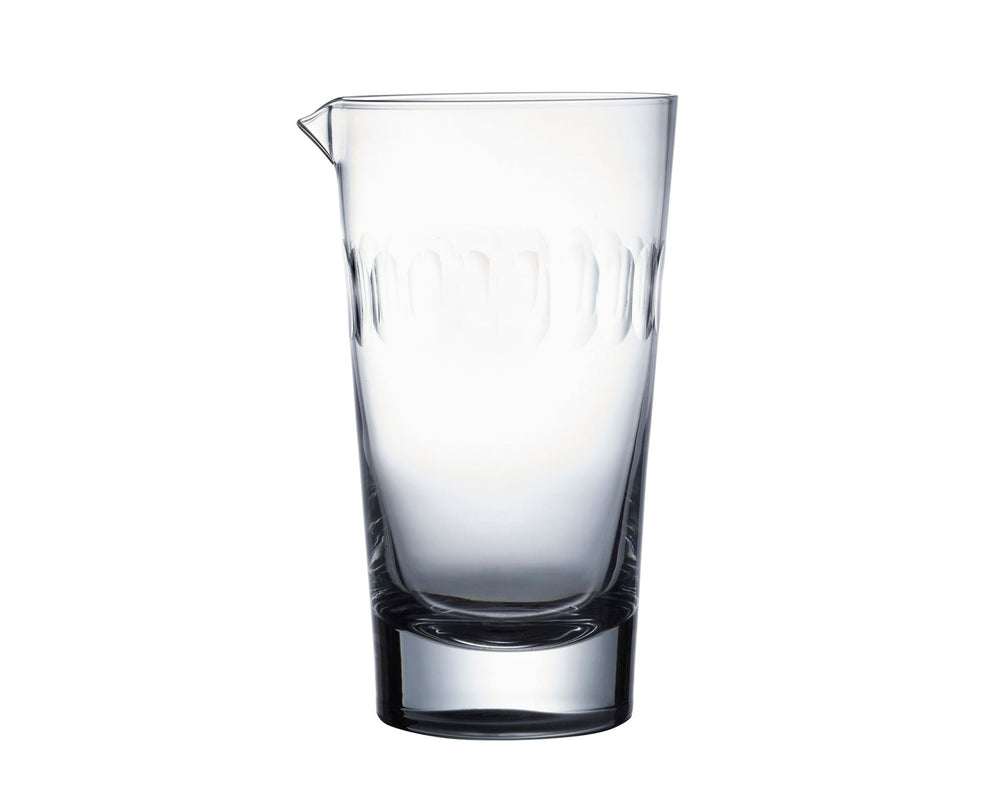 Front view of mixing glass showcasing hand-cut connecting oval lens engraving and small pouring spout on white background