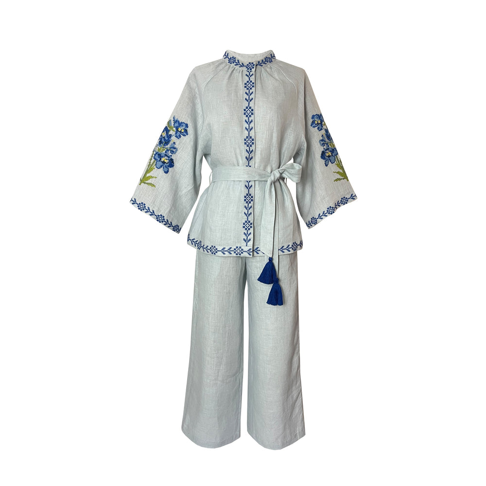 Front view of Blue Linen Set showcasing embroidered floral motifs and tasseled belt on a white background
