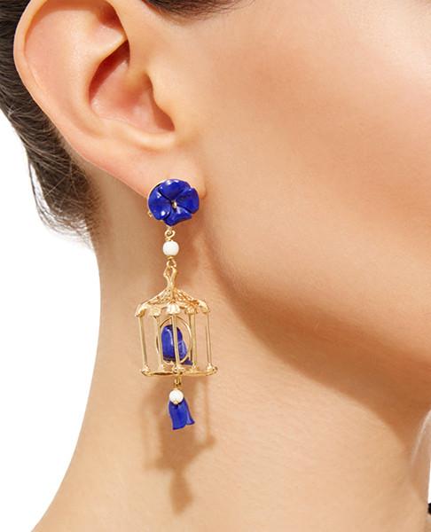 Side view of Pagoda Earring in Jade showcasing a birdcage with jade and white agate, worn on an ear against a white background