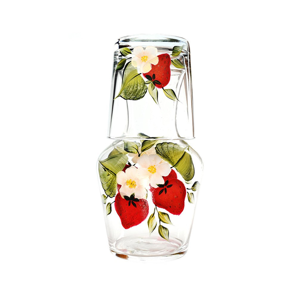 Front view of Strawberry Carafe And Tumbler showcasing hand-painted strawberries, flowers, and leaves on clear glass with white background