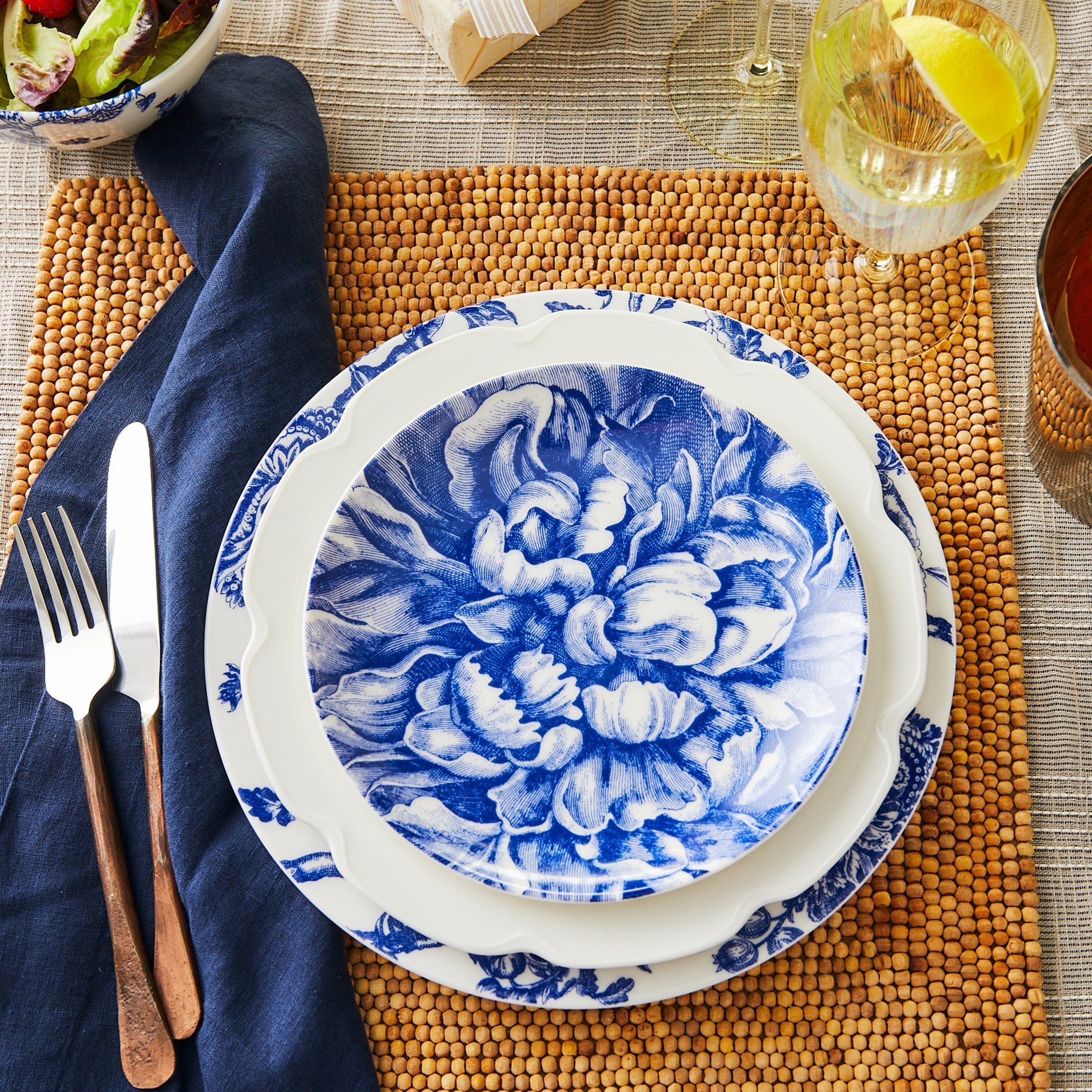 A Peony Full Bloom Coupe Salad Plate with Caskata Artisanal Home brand, blue and white porcelain plate with Peony flowers on it.