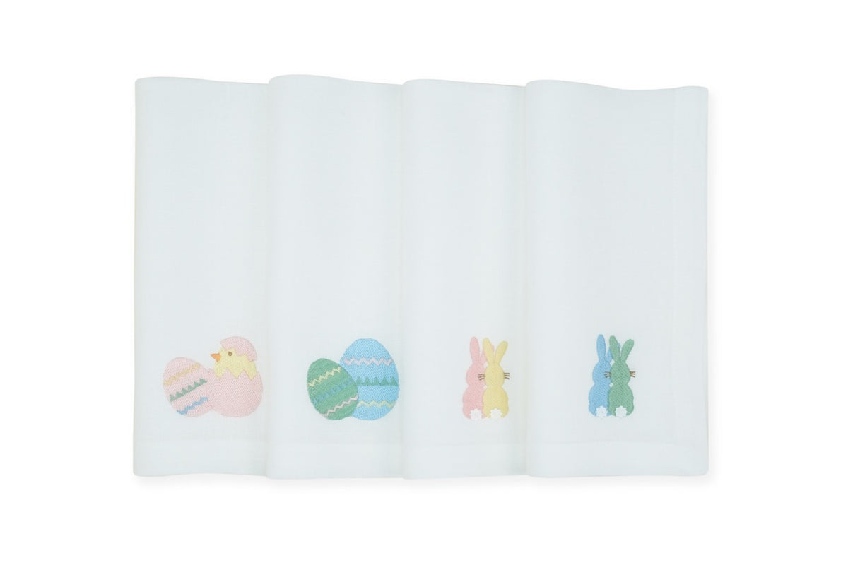 Front view of set of 4 white linen napkins showcasing embroidered pastel Easter motifs: chick, decorated eggs, and pink and blue bunnies