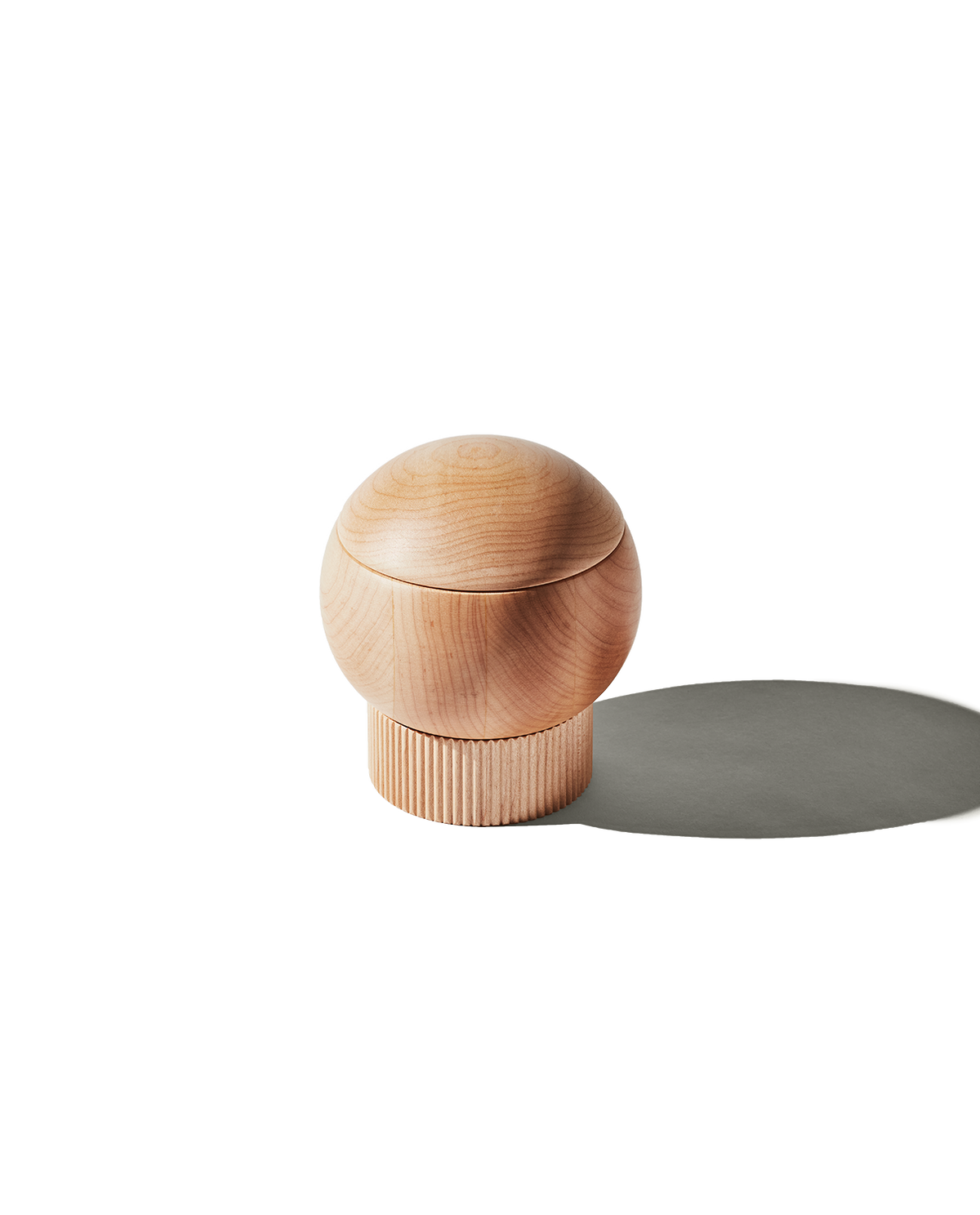 Front view of The Salt Sphere showcasing its magnetic swivel lid and fluted wood base on a white background