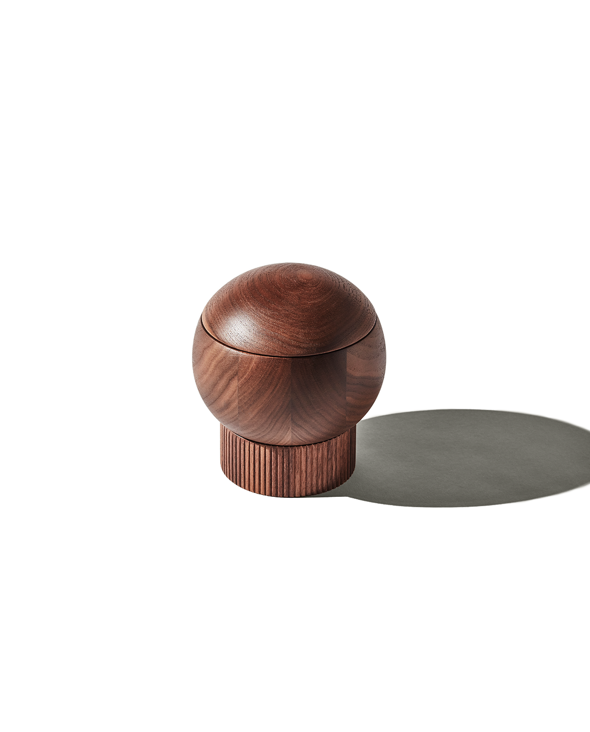 Front three-quarter view of The Salt Sphere showcasing its domed lid and fluted base on a white background