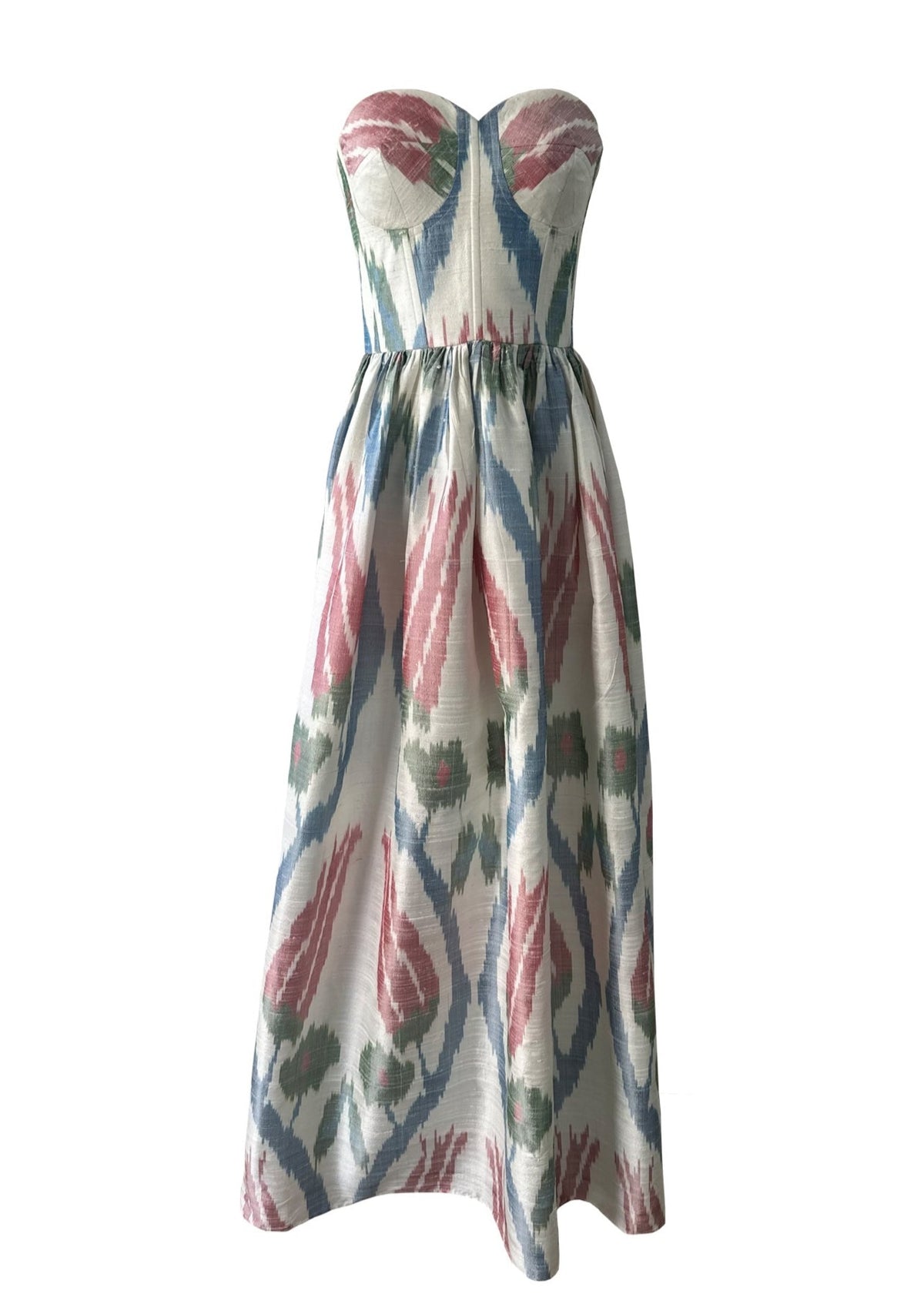 Front view of Tulip Dress with strapless sweetheart bodice, cinched waist and full skirt in red, blue and green ikat