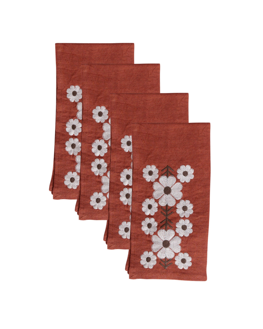 Four folded Tulpina napkins in brick red showing white embroidered floral motif on white background